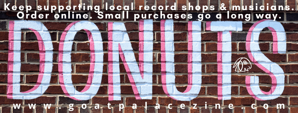 Donut sign painted on a brick wall.