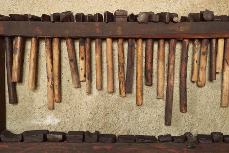 Wall rack of old hammers.