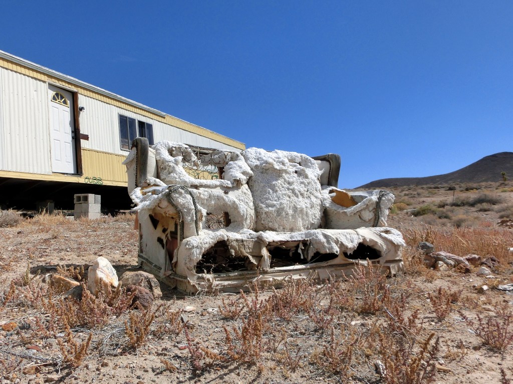 Dead trailer in a desert.