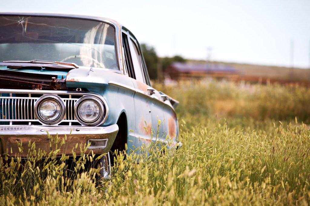 Abandoned car in a field