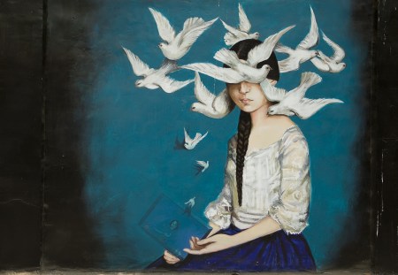Graffiti of a girl surrounded by white doves