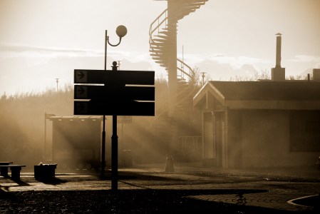 A train station platform in soft fading afternoon light.